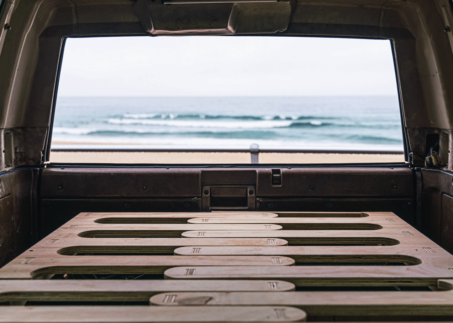Byron Base Car Camp Bed in Boot of 4WD facing towards the bondi beach