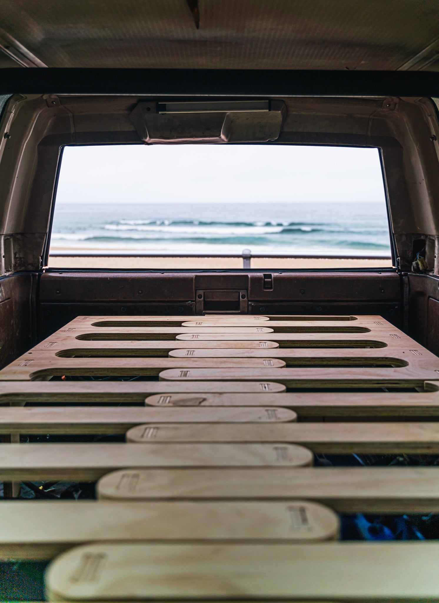 ByronBase Camp Bed inside a 4WD, Toyota 4 Runner with a view of Bondi Beach